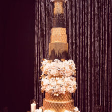 SIMONE AND PATRICK - - as seen on Food Network "Ridiculous Cakes" - 7 foot tall wedding cake with handcrafted flowers and bling. Photo: Moxie Studio